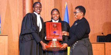 The winning UCU team receives the award from Minister for ICT and National Guidance Justine Kasule Lumumba after the final of the Unwanted Witness Privacy Moot Court Competition.