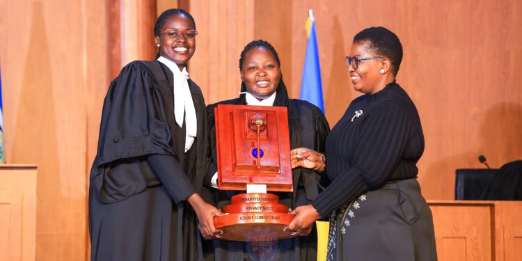 The winning UCU team receives the award from Minister for ICT and National Guidance Justine Kasule Lumumba after the final of the Unwanted Witness Privacy Moot Court Competition.