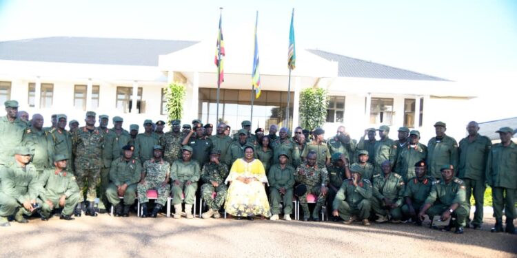 Minister for the Presidency Milly Babalanda poses for a photograph with senior military and civilian officers of Operation Wealth Creation (OWC) during a week-long capacity-building retreat at the National Leadership Institute (NALI) in Kyankwanzi.