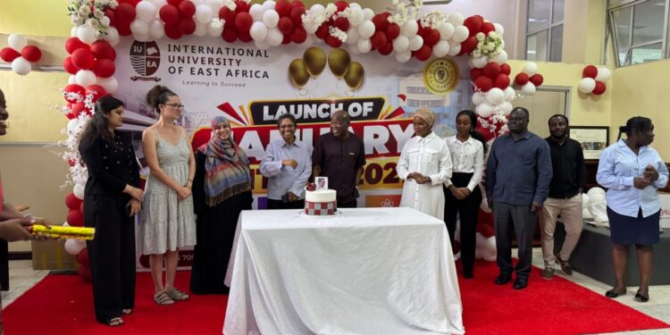 International University of East Africa Vice Chancellor Prof. Emeka Akaezuwa joins students in cutting a cake during the launch of the university’s January 2027 intake at its Kansanga campus in Kampala.