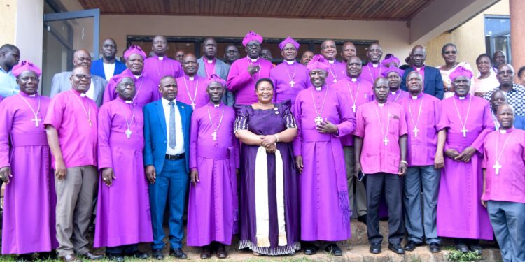 A team of clergy pose for a group photo with Minister for the Presidency Milly Babalanda during the 141st commemoration of Bishop James Hannington in Mayuge District.