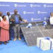 Stanbic's Executive Head of Business and Commercial Banking, Tunde Thorpe, handing over a gift to the acting District Education Officer, Joy Wamalugu